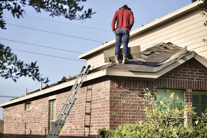 Professional roofer working on a residential roof in Whispering Pines
